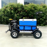 Small off-road vehicle with a blue cooler on a concrete surface with greenery in the background