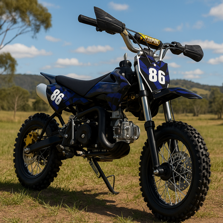 Outdoor shot of blue and black dirt bike on dirt terrain with trees in the background, positioned front-left to show tread and stance.