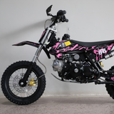 Left-side view of the dirt bike, showing kickstand down and full profile with visible engine and frame.