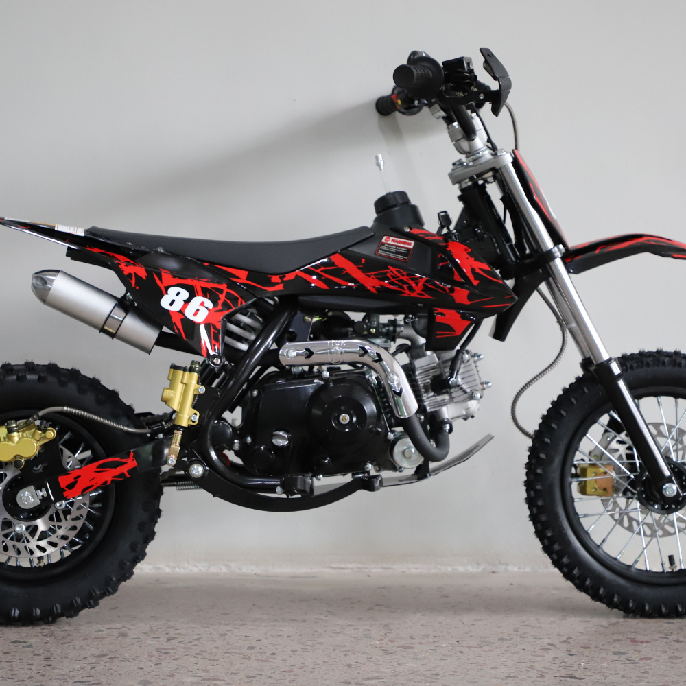 Right-side close-up view of the dirt bike, focusing on engine detail, swingarm, and chain area.