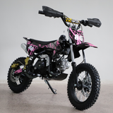 Right-side close-up view of the dirt bike, focusing on engine detail, swingarm, and chain area.