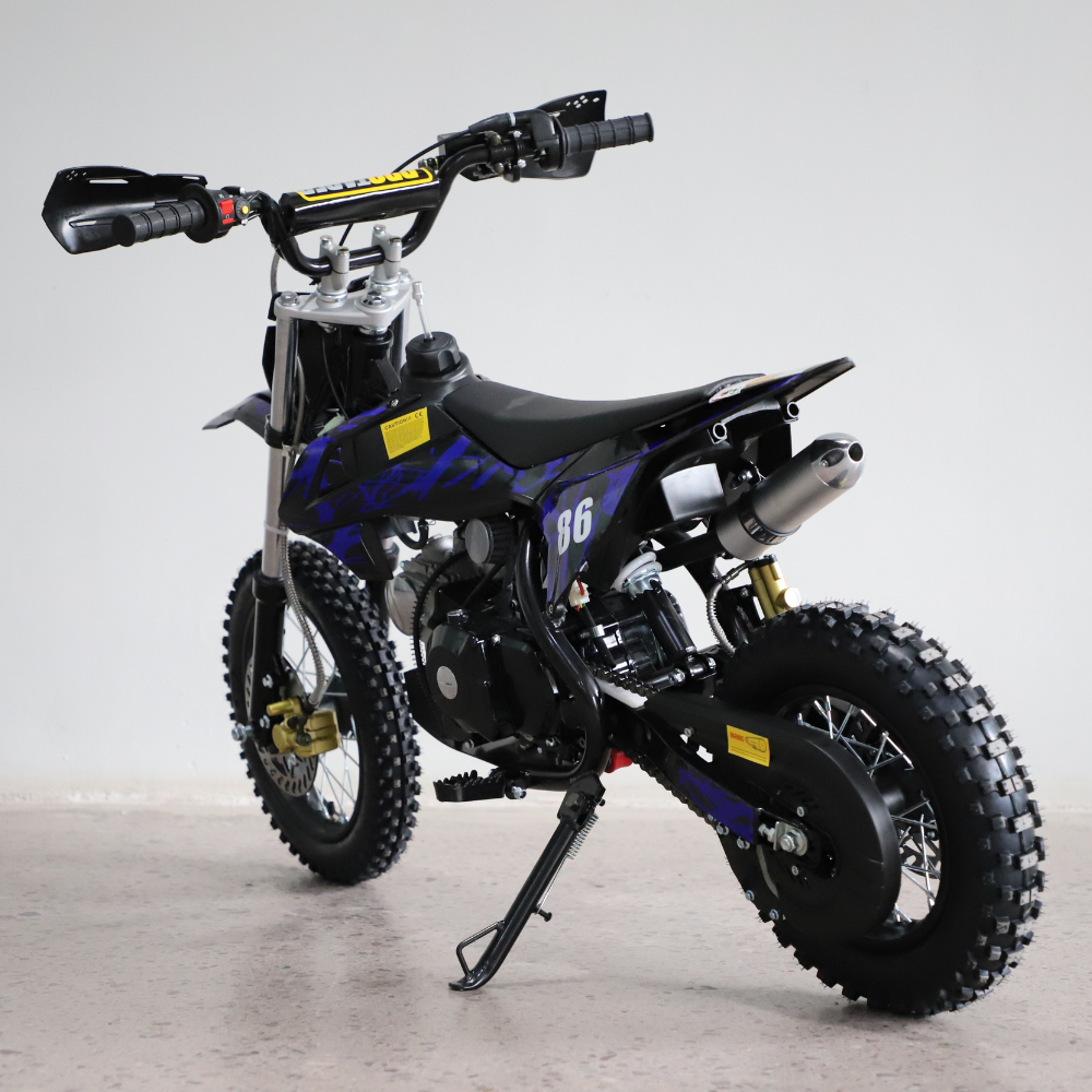 Side view of the 50cc dirt bike facing right, showcasing full body graphics and handlebar detail against a white background.