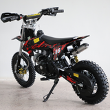 Left-side view of the dirt bike, showing kickstand down and full profile with visible engine and frame.


