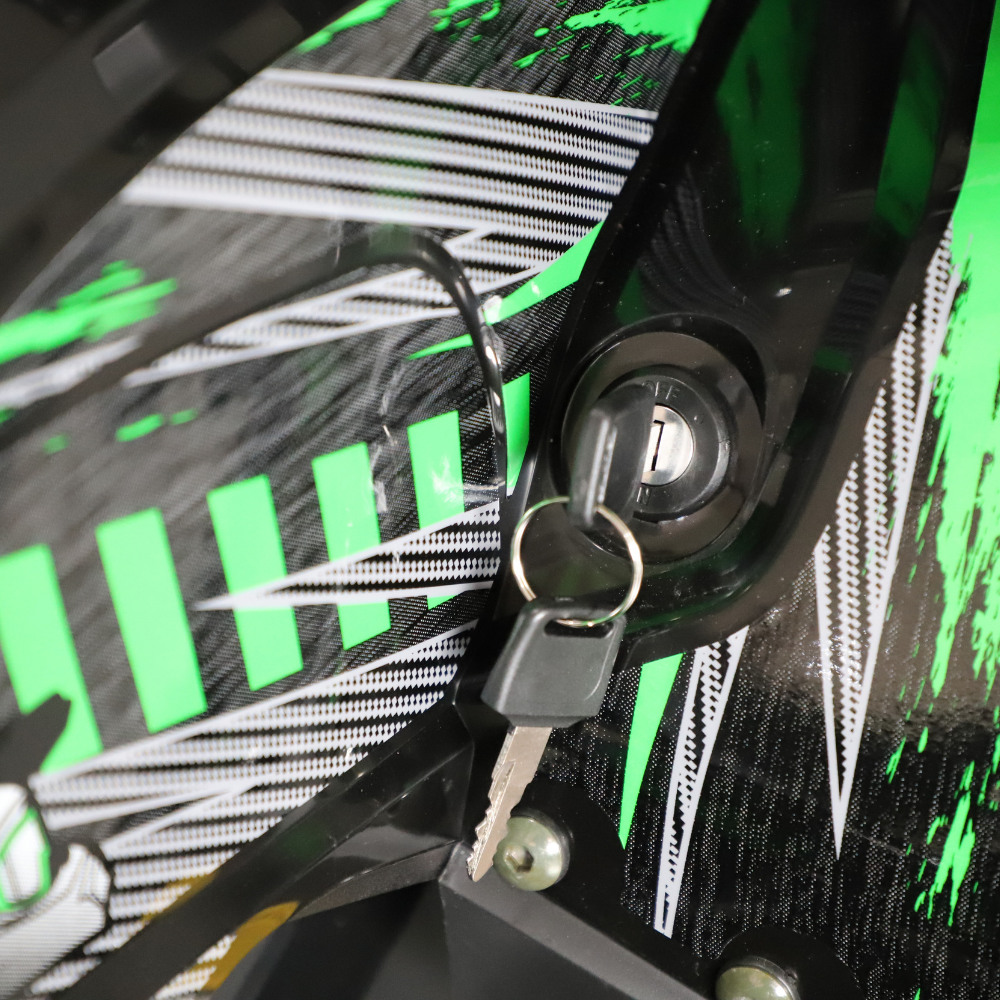 Close-up of a key attached to a motorcycle ignition lock with a colorful background