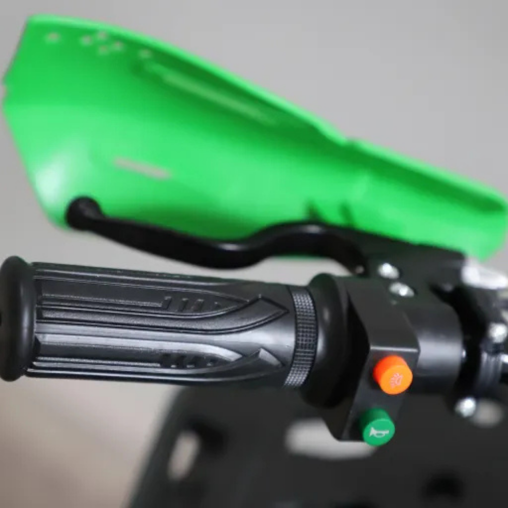 Close-up of motorcycle handlebar with green fairing on a blurred background