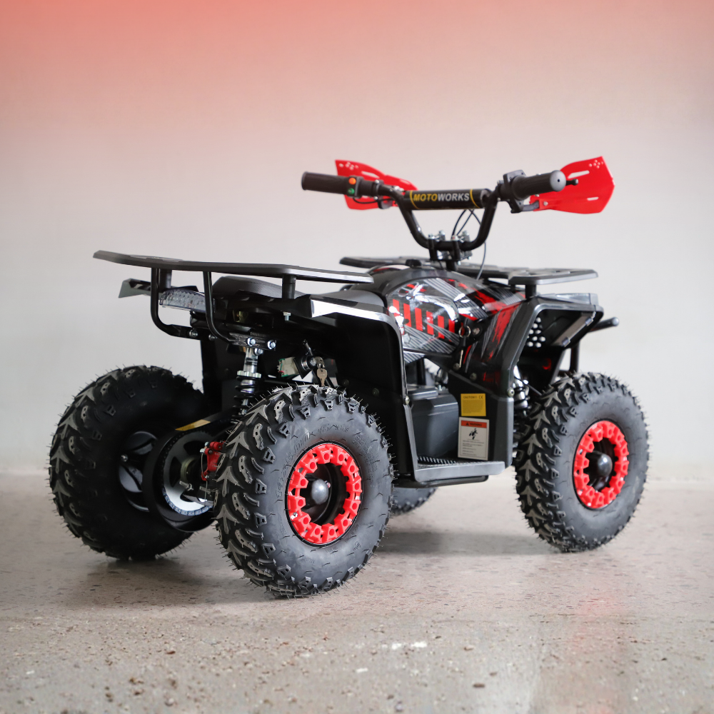 Black and red ATV on a gray surface with a gradient background