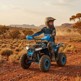 Person riding a blue ATV in a desert landscape with mountains in the background