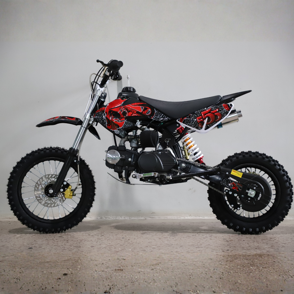 Small dirt bike with red and black design on a gray background