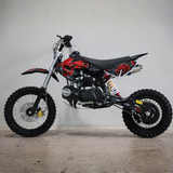 Small dirt bike with red and black design on a gray background
