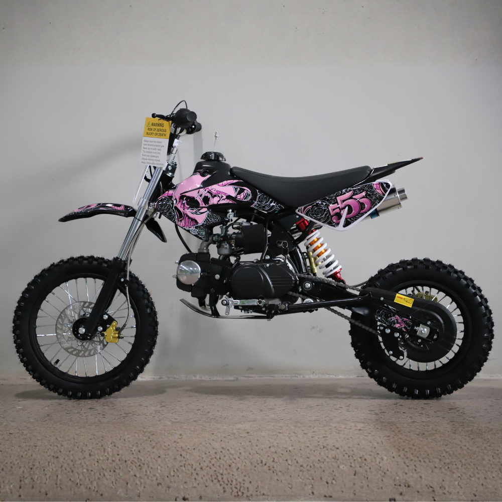 Black and pink dirt bike with skull design on a gray background