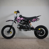 Black and pink dirt bike with skull design on a gray background