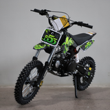 Children's dirt bike with green and black design on a gray background