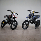 Two dirt bikes on a gray background