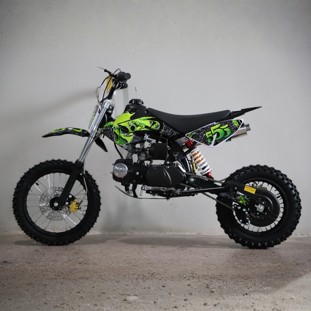 Small dirt bike with green and black design on a gray background