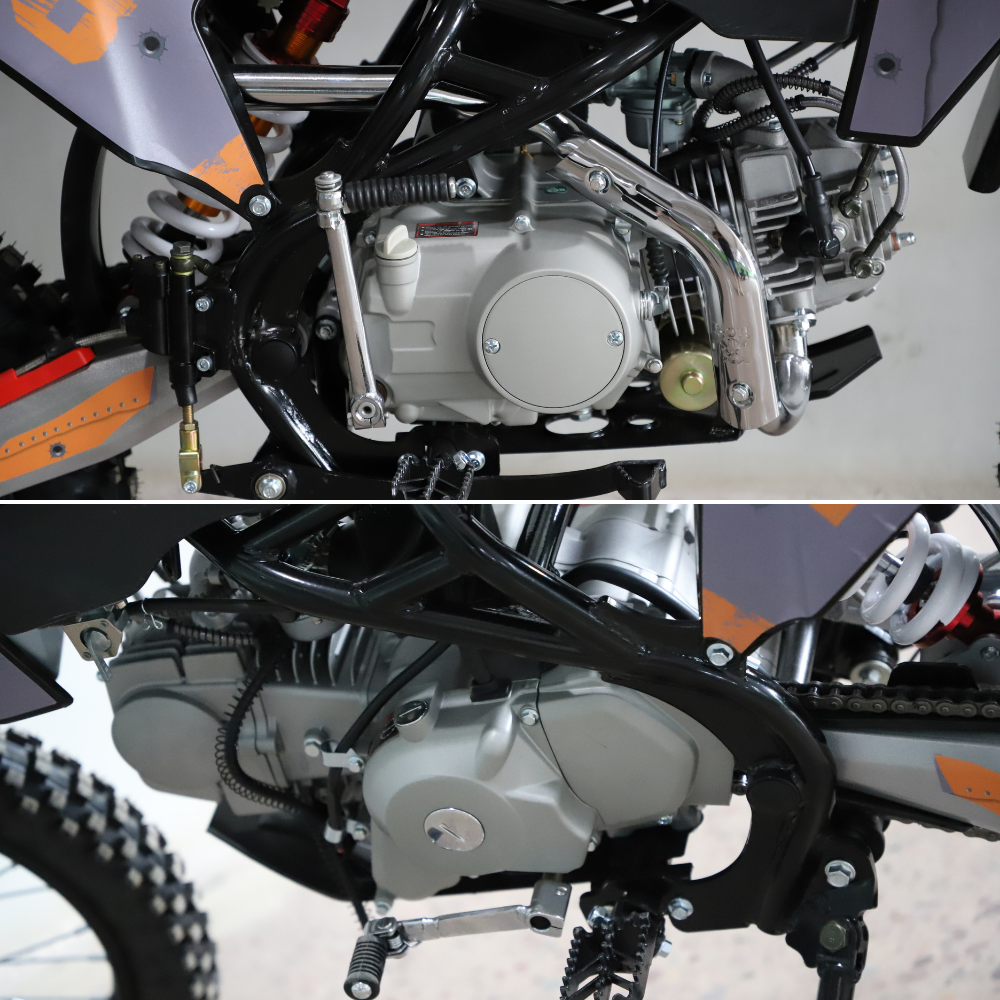 Close-up of a motorcycle engine and frame, showing the silver engine casing, black frame tubes, metal chain guard, and part of the bike's wheel and body panels.