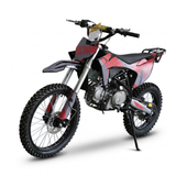 A red and black dirt bike with knobby off-road tires, a silver engine, and a black seat, shown on a white background with its kickstand down.