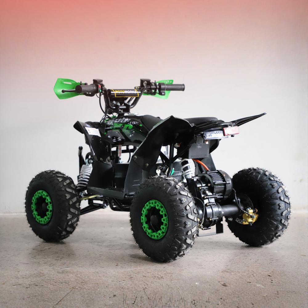 Black and green ATV on a gray surface with a gradient background