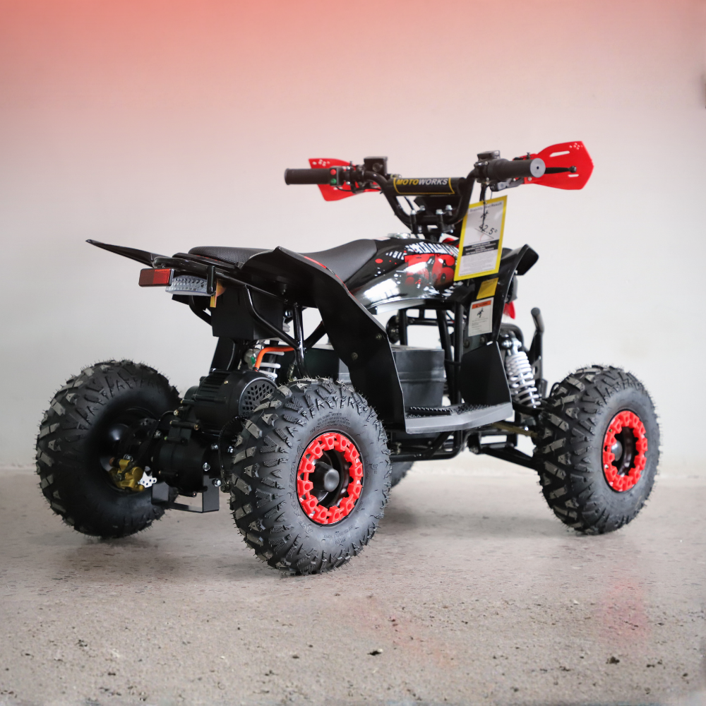 Black and red ATV on a gray surface with a gradient background