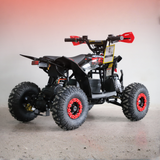 Black and red ATV on a gray surface with a gradient background