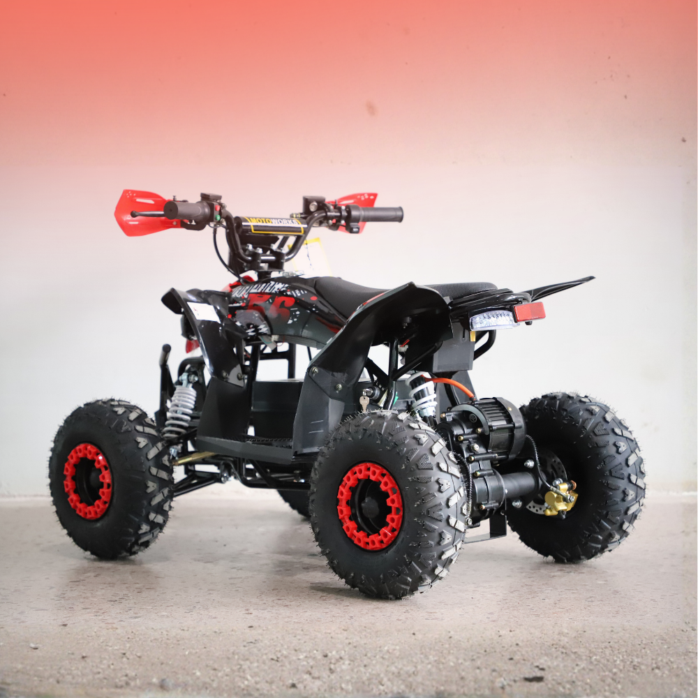 Black and red ATV on a gray surface with a gradient background