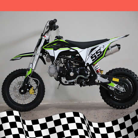 A full right-side view of the dirt bike, highlighting the frame and exhaust system against a checkered base background.