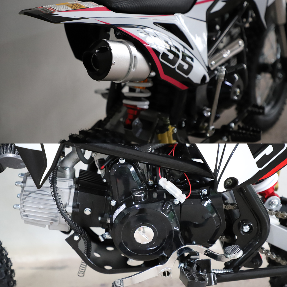 Close-up of a motorcycle's exhaust and engine components on a gray background.