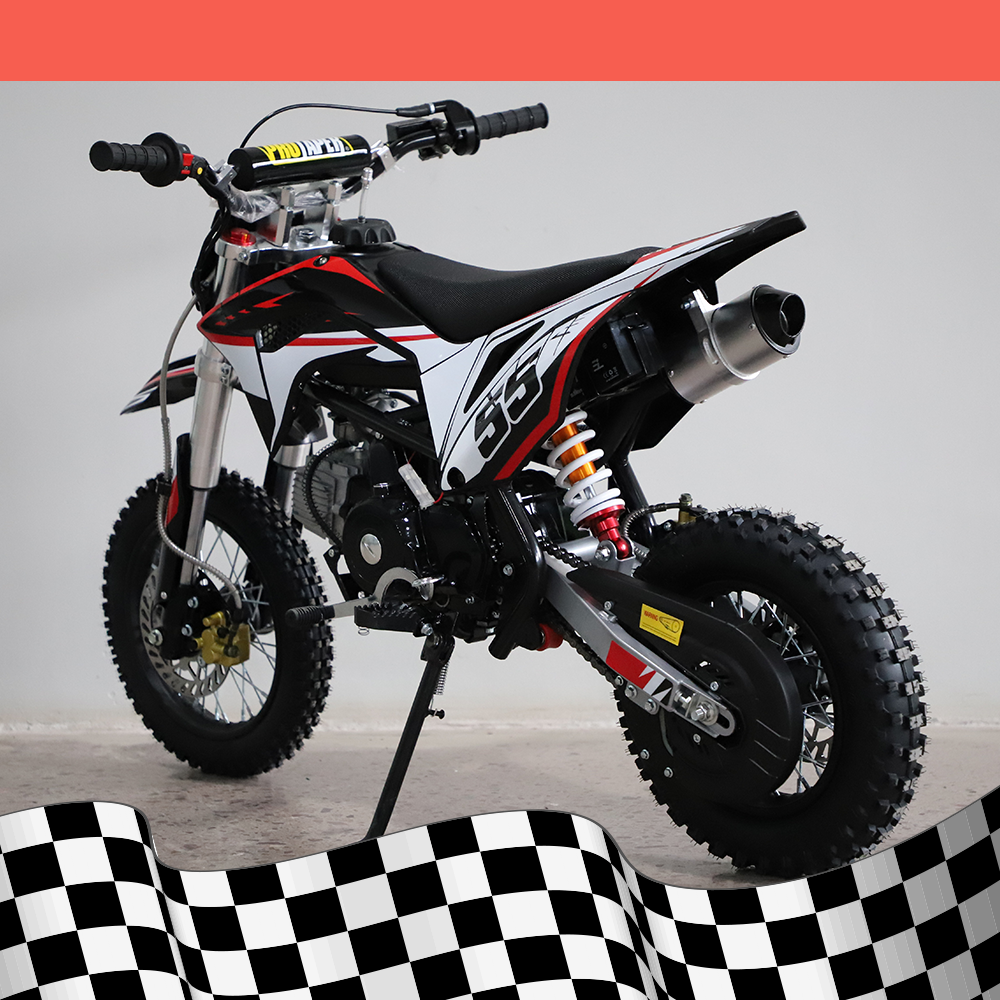 A back-right angled view of the dirt bike, showcasing the exhaust pipe and rear suspension, on a checkered background