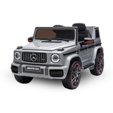 A silver Mercedes-Benz G-Class style children's ride-on toy car with black seats, black wheels, and red accents, shown on a plain white background.