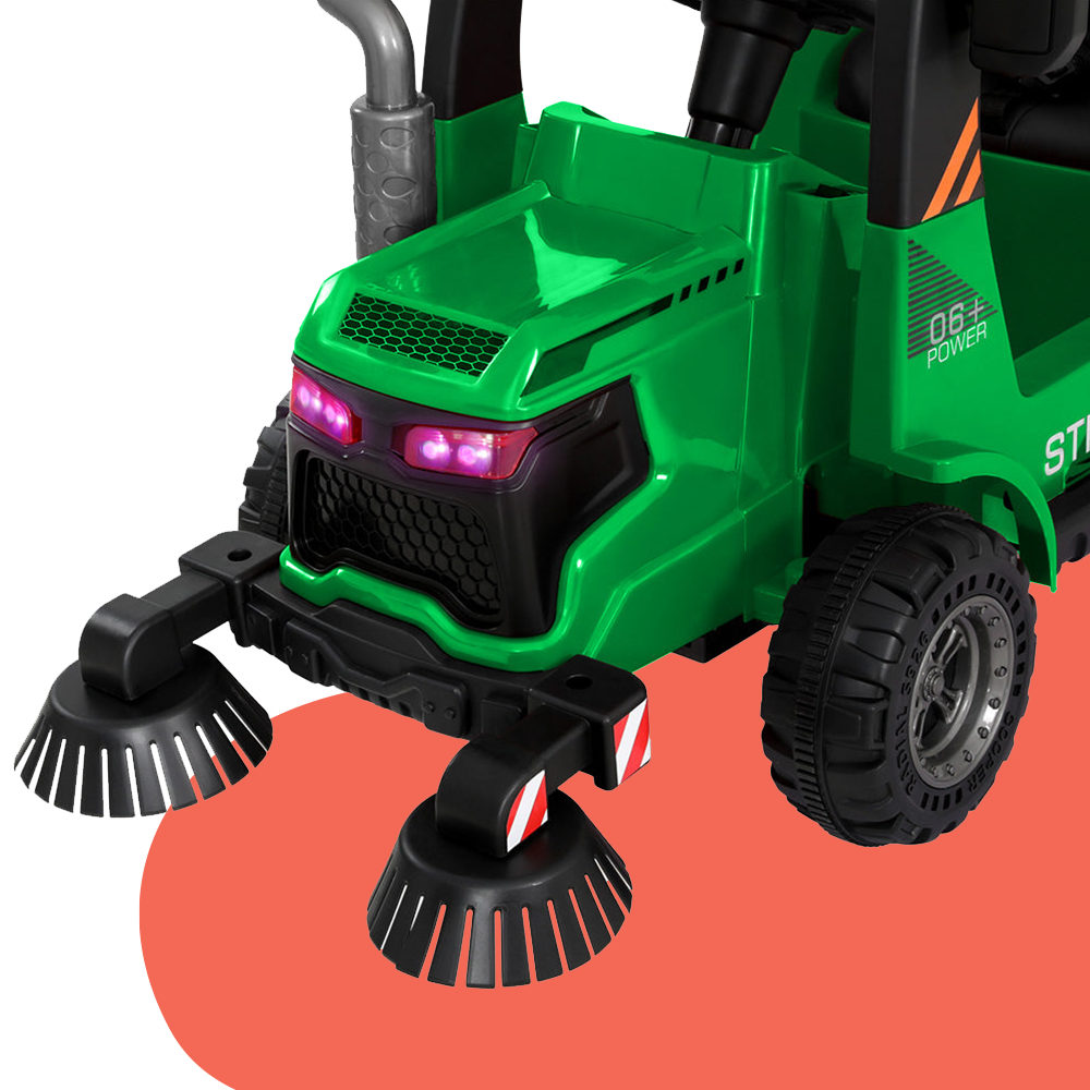 Front close-up view of the green ride-on street sweeper truck, highlighting the broom-like brush attachments and detailed lights