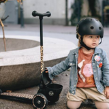 kid holding the Scoot & Ride Highwaykick 2 Kids 3-Wheel Scooter with Storage - Leopard