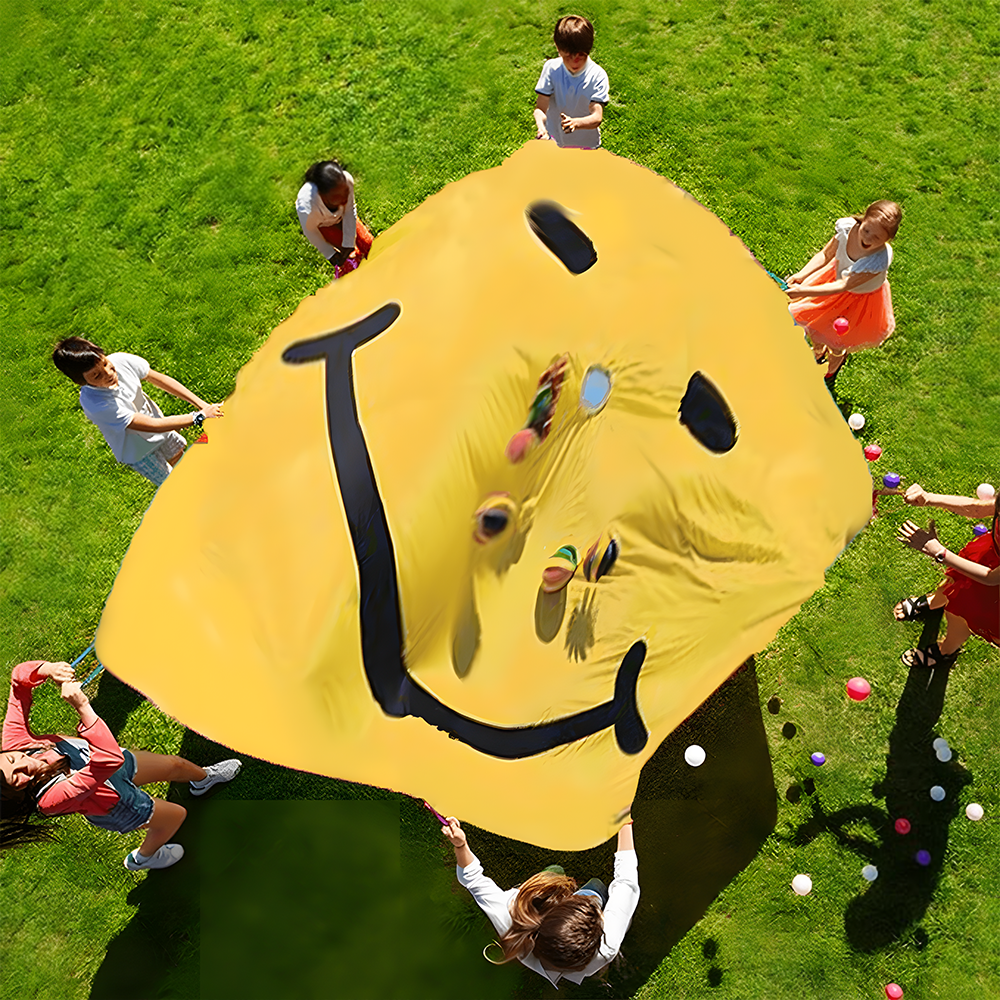 Children holding up a yellow parachute with a black smiley face, while tossing colourful balls into the air