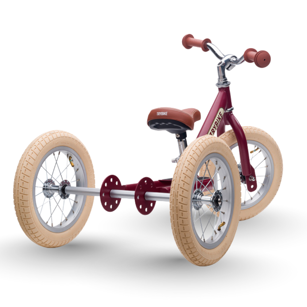 Red tricycle with beige tires on a white background