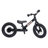 Black balance bike with 'TRYBIKE' branding on a white background