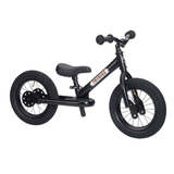 Black balance bike with a seat on a white background