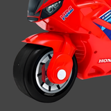 Close-up of a red toy motorcycle with visible branding on a gray background