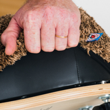 Hand with a ring on a black surface of a ride on wheely bug