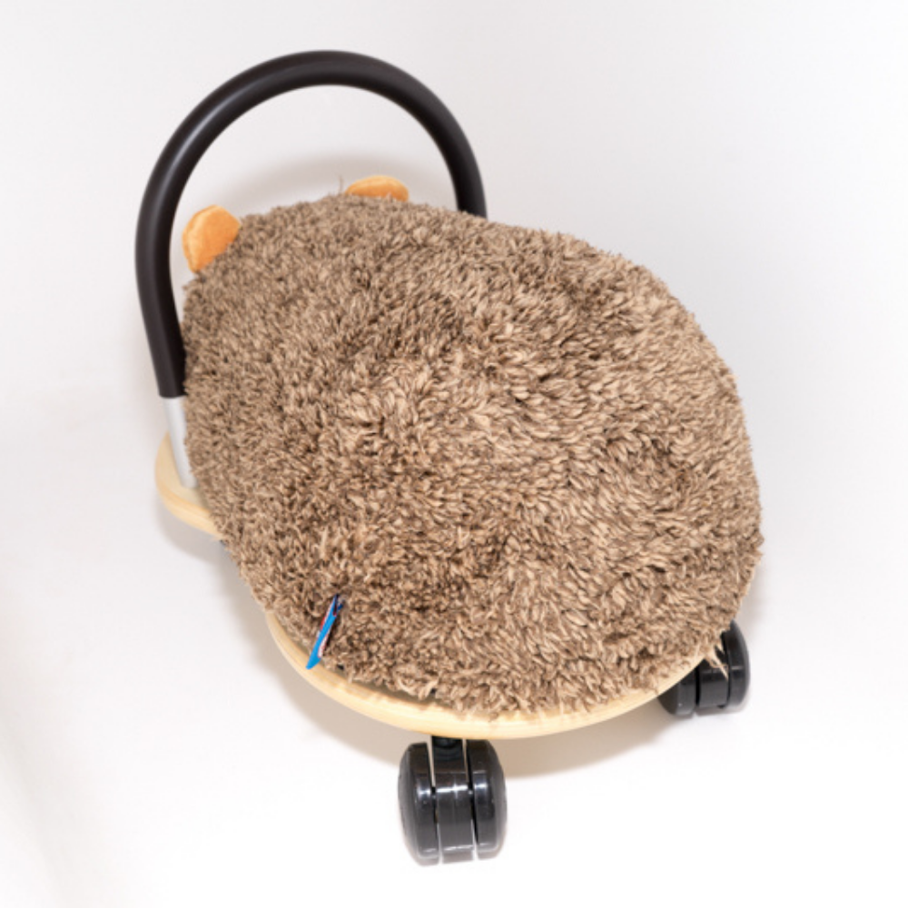 a fluffy brown seat of a wheely bug hedgehog on a white background