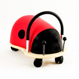 Red and black ladybug-shaped toy on a white background
