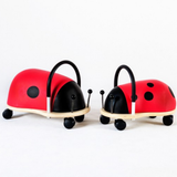 Two red and black ladybug-shaped chairs on a white background