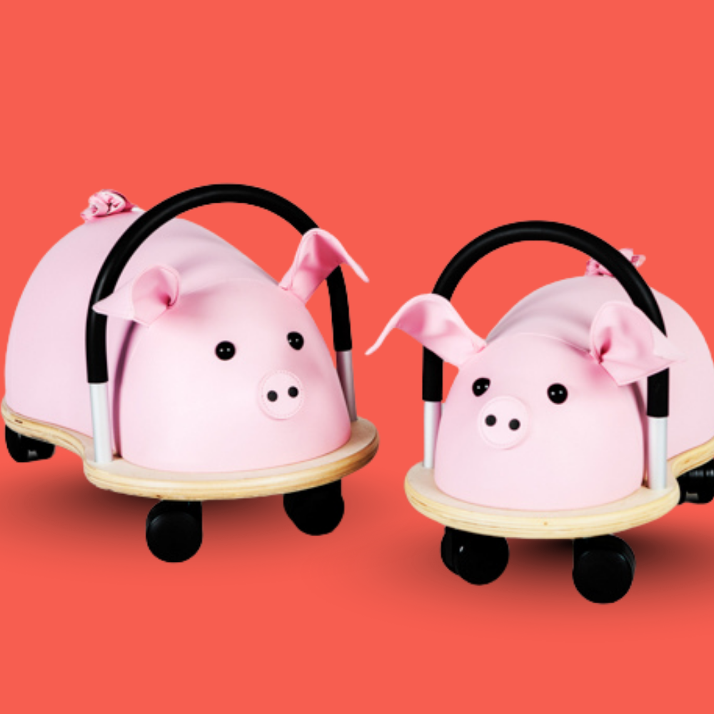 Two pink pig-shaped scooters on a red background