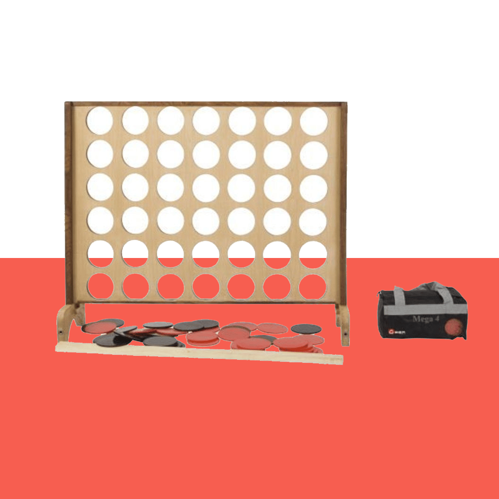 Giant wooden Connect Four game set on a red background, with black and red game discs scattered at the base and a carrying bag labeled 'Mega 4' on the right side