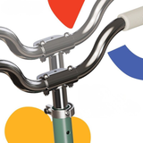 Close-up of bicycle handlebar with colorful geometric shapes on a white background