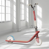 Red scooter with white wheels in a bright room with large windows