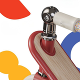 Close-up of a skateboard with colorful geometric shapes in the background