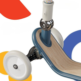 Close-up of a children's balance bike with colorful wheels on a white background