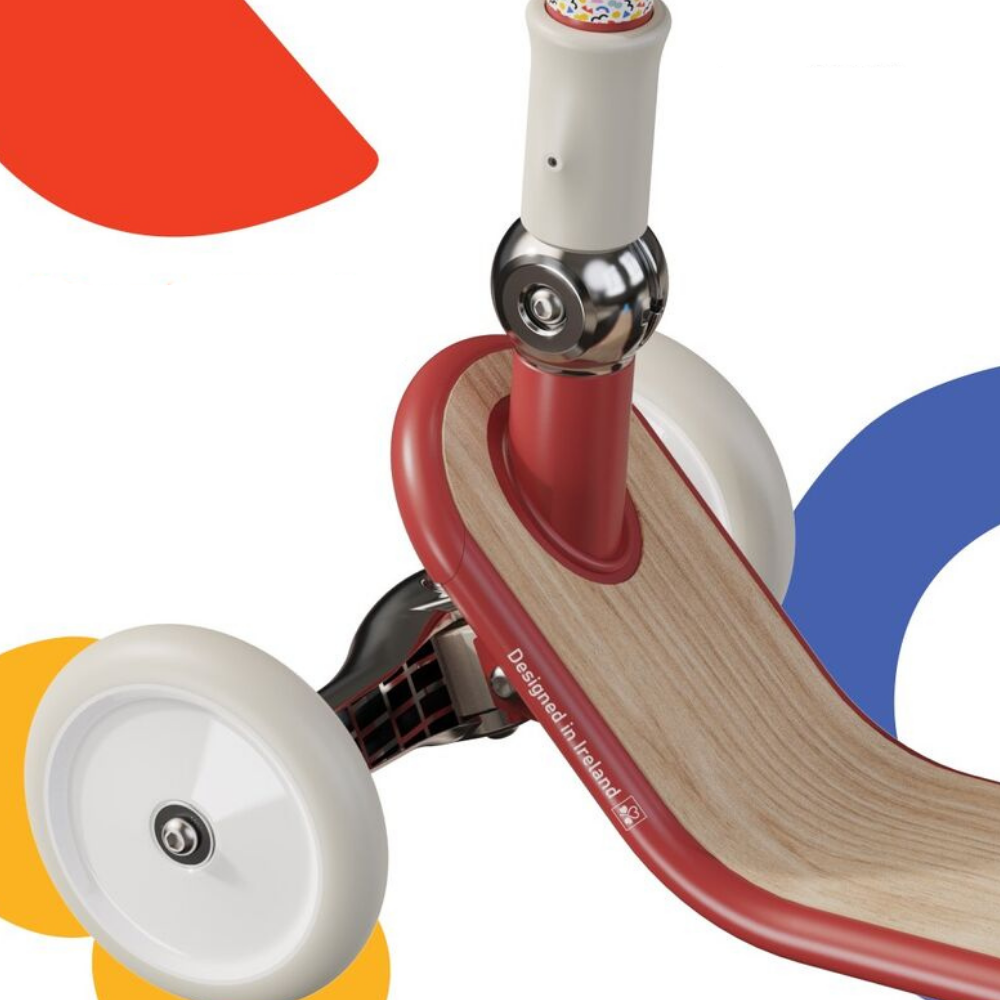 Close-up of a children's balance bike with colorful wheels on a white background