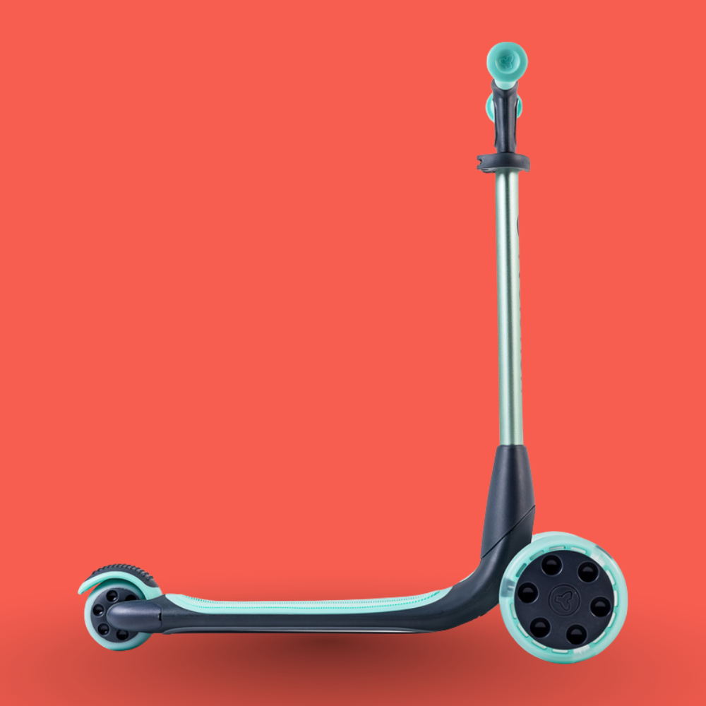 Children's scooter with teal accents on a red background