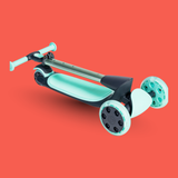 Green scooter with white wheels on a red background
