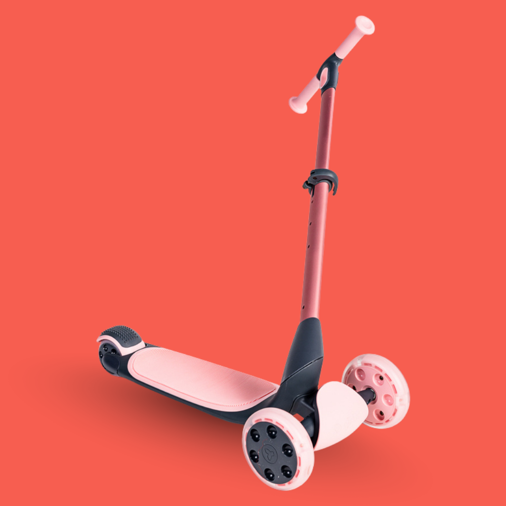 Children's scooter with pink deck and black frame on a red background