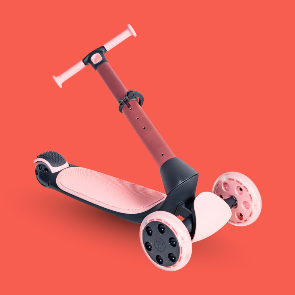 Children's scooter with pink and black design on a red background